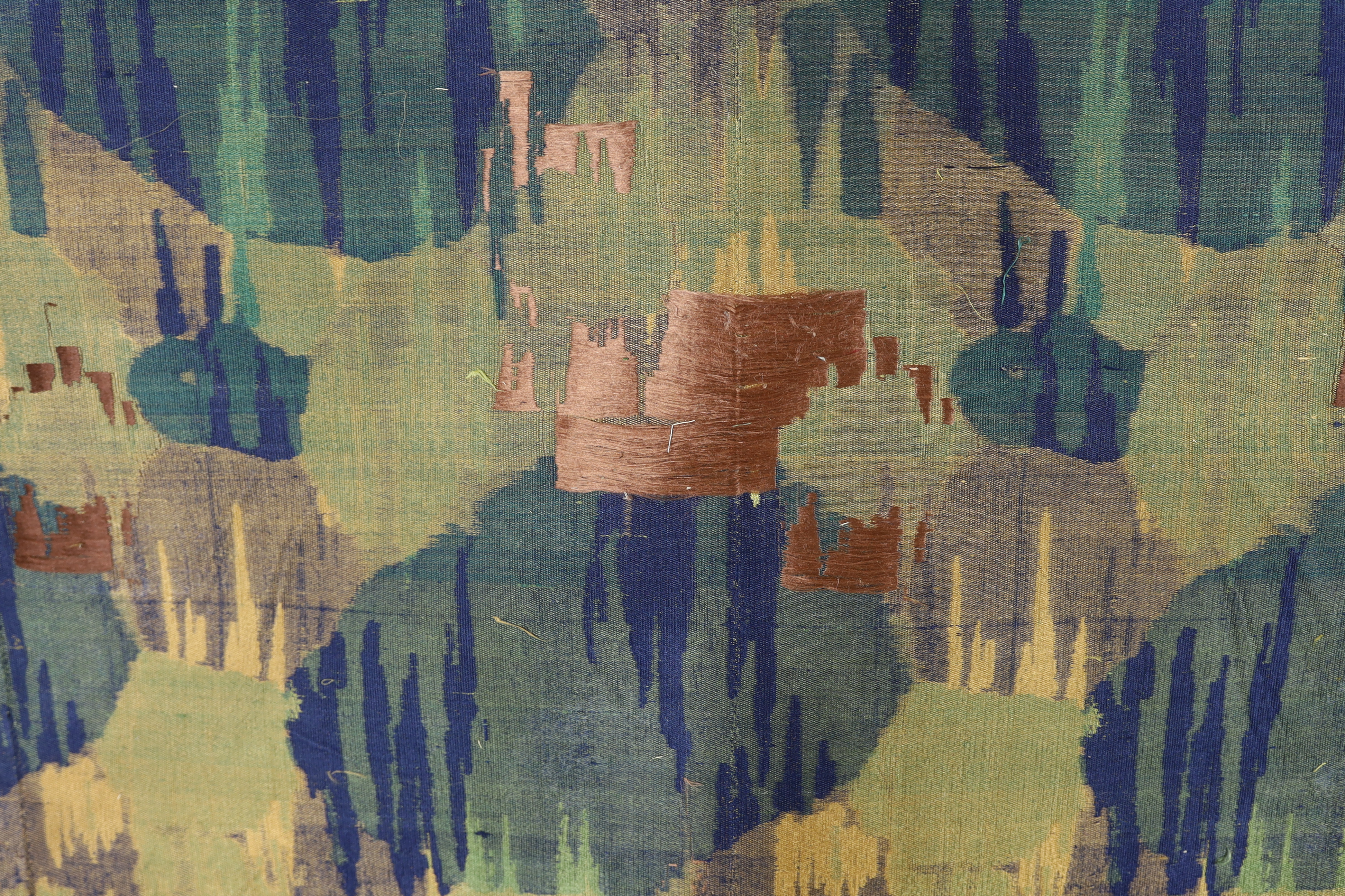 A 1930’s Japanese Kyoto, possibly Nishijin and a Tsumugi hand loomed brocade, woven in fine gold and multi coloured threads, in an abstracted mountainous landscape pattern, originally possibly woven for an Obi, 69cm wide